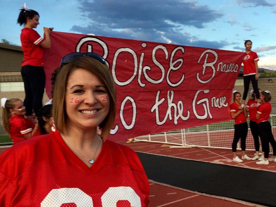 Mrs.Kathryn Rotchford, a Boise High English teacher, smiles as she gets ready to help make the tunnel at the 2016 Boise High Homecoming football game.