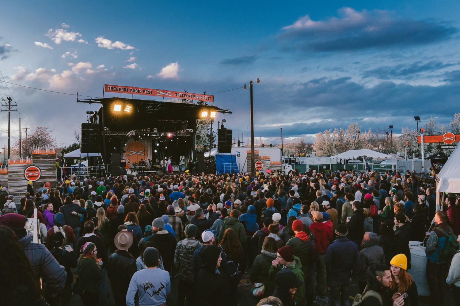 Crowds gather around the main stage as bands light up the night.