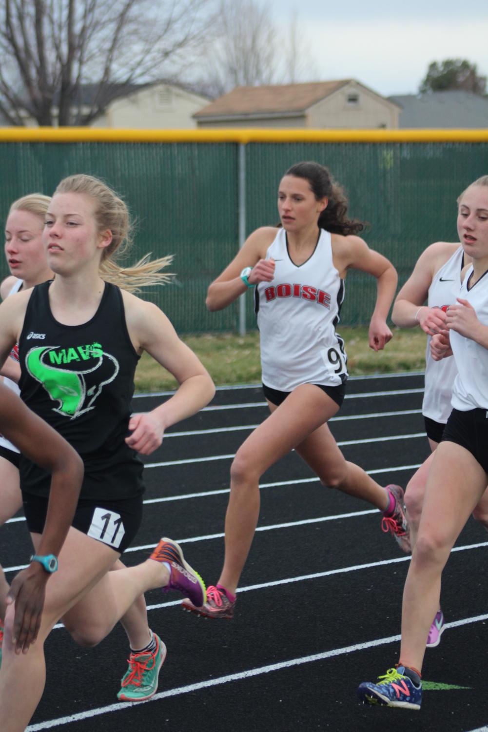 Long-distance athletes battle it out against other schools in the mile run.