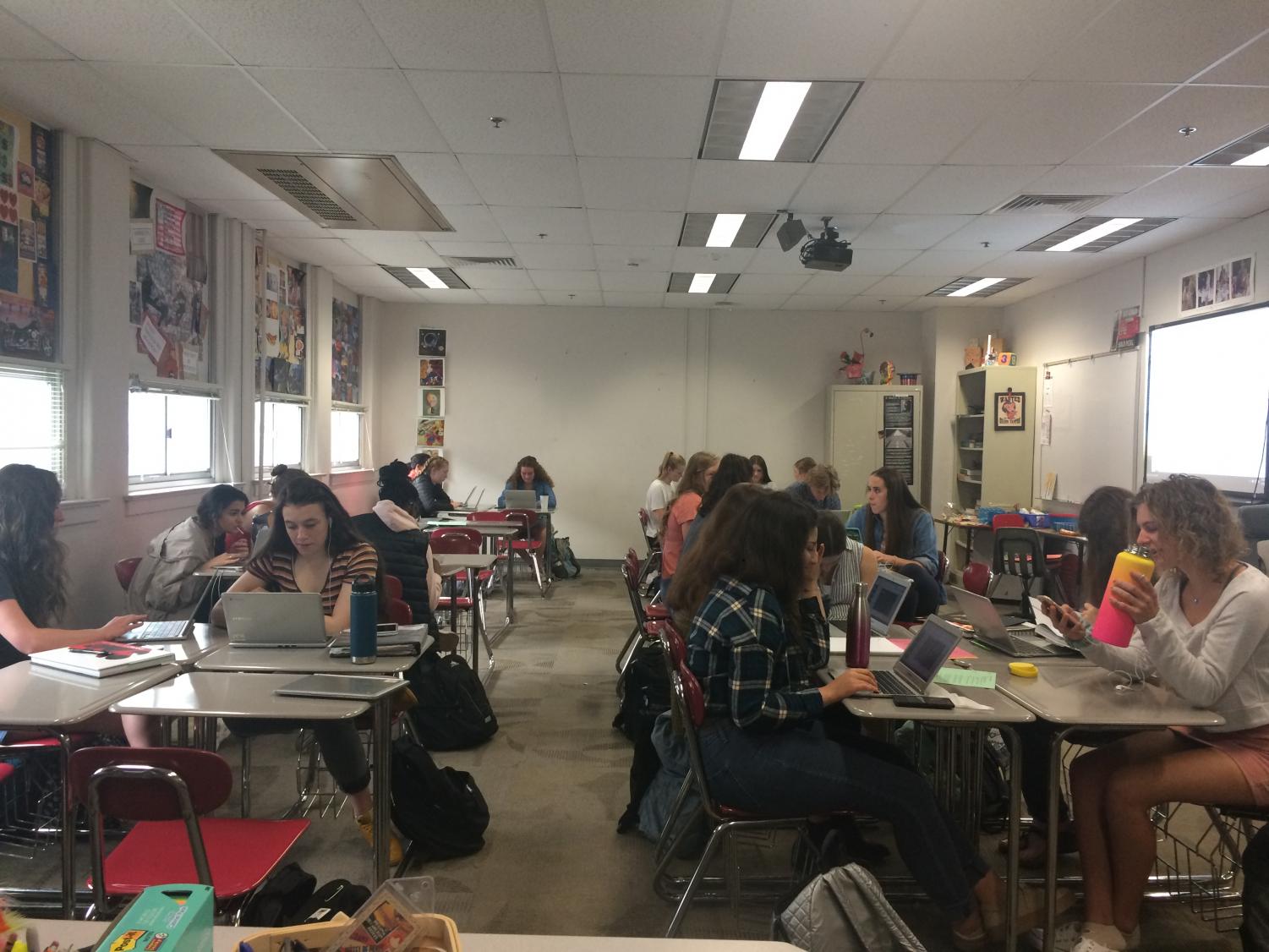 AP Language and Composition students work diligently on a group project.