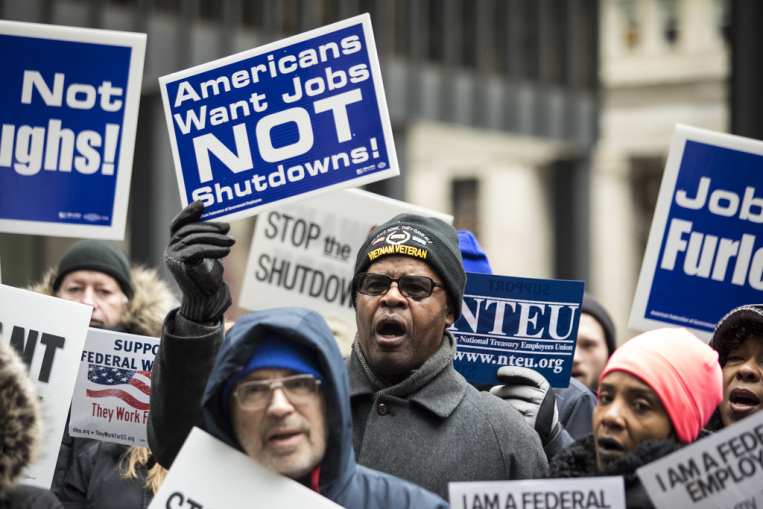 Despite President Trump’s assertion that federal workers “agree 100% with what I’m doing”, thousands of employees have taken to the streets in protest as the shutdown continues into Friday.