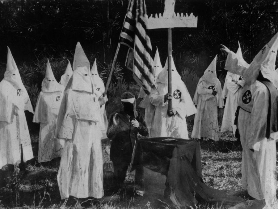 KKK recruitment ceremony in 1922 (Topical Press Agency/Getty Images).