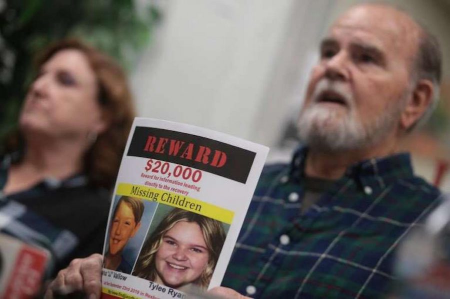 Kay and Larry Woodcock, the grandparents of JJ Vallow and Tylee Ryan, holding up a reward poster of their missing grandchildren as they talk to Rexburg media. 
