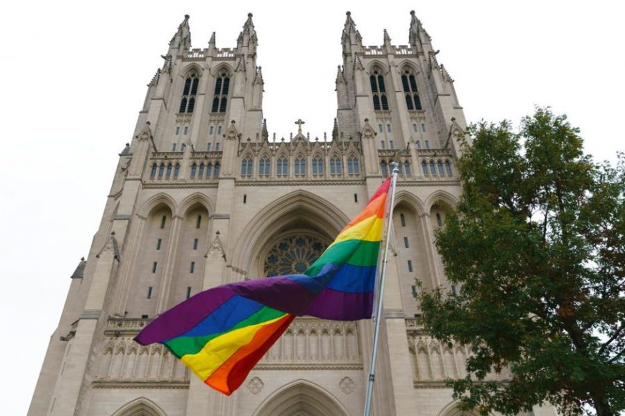 An image of a pride flag, a symbol of solidarity and pride for the LGBTQ+, community being displayed outside a church to show support. (AP/Carolyn Kaster)