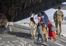 “An Afghan family being evacuated by the US air force from the airport in Kabul.”