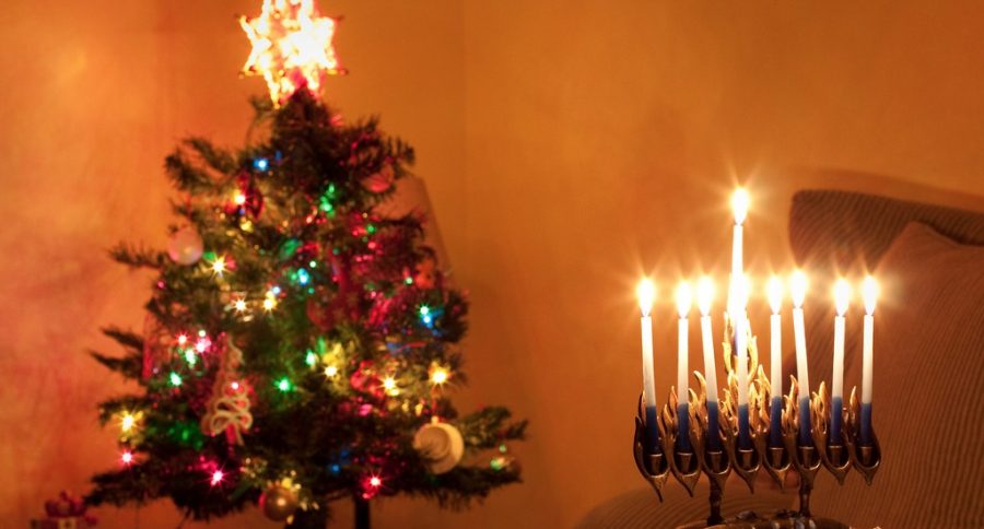 A picture of two religious symbols next to each other, a Christmas tree and a Menorah