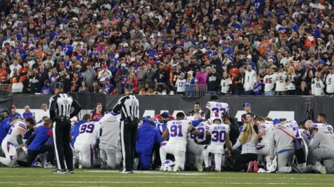 Bills and Bengals players gather around in a prayer circle as Hamlin was getting stretchered off the field (ABC 7).
