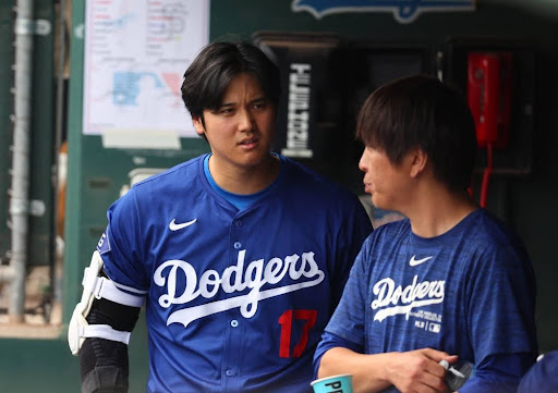 Shohei Ohtani (left) and Ippei Mizuhara (right) during a spring training game. 
